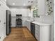 Modern kitchen with stainless steel appliances, white cabinets, wood floors, and subway tile backsplash at 2560 Palmetto Hall Blvd, Mount Pleasant, SC 29466