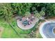 Aerial shot of a playground with lots of equipment surrounded by green grass and lush trees in a fenced in area at 2560 Palmetto Hall Blvd, Mount Pleasant, SC 29466