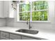 Close up of a stainless steel sink, white counters, and a window with a wooded view at 2560 Palmetto Hall Blvd, Mount Pleasant, SC 29466