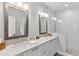 Modern bathroom with double vanity, framed mirrors, and a glass enclosed shower with subway tiles at 2578 Helmsman Rd, Johns Island, SC 29455