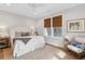 Bedroom with a white bed, decorative pillows, rug, and chair near a window at 2578 Helmsman Rd, Johns Island, SC 29455