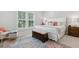 Well-lit bedroom featuring shutters, neutral tones, a patterned rug, and soft, inviting textures at 2578 Helmsman Rd, Johns Island, SC 29455