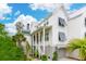 Beautiful two-story home with a inviting porch, louvers, lush plants and a metal roof at 2578 Helmsman Rd, Johns Island, SC 29455