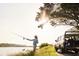 Personal fishing at the water's edge, backed by a vehicle and natural scenery, promoting outdoor recreation at 2578 Helmsman Rd, Johns Island, SC 29455