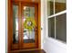 Elegant wooden front door with glass panes and a charming wreath at 2578 Helmsman Rd, Johns Island, SC 29455