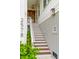 Inviting front porch with beautiful wooden door, staircase and stylish lighting fixture at 2578 Helmsman Rd, Johns Island, SC 29455