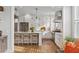 Open concept kitchen with stainless appliances, a kitchen island with seating, and white cabinetry at 2578 Helmsman Rd, Johns Island, SC 29455