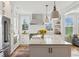 Spacious kitchen with white cabinets, stainless steel appliances, large island, and pendant lighting at 2578 Helmsman Rd, Johns Island, SC 29455