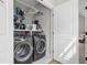 Convenient laundry room with side-by-side washer and dryer and storage shelving at 2578 Helmsman Rd, Johns Island, SC 29455