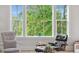 Comfortable living room area with chairs and a window with lush greenery outside at 2578 Helmsman Rd, Johns Island, SC 29455