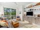 Bright living room with a sliding glass door, built-in shelving, and comfortable seating area at 2578 Helmsman Rd, Johns Island, SC 29455