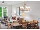 Living room featuring a chandelier, dining table, a large window, and comfortable seating at 2578 Helmsman Rd, Johns Island, SC 29455