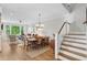 Bright and airy living room featuring hardwood floors, a dining area and staircase at 2578 Helmsman Rd, Johns Island, SC 29455