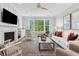 Cozy living room with fireplace, built-in shelving, and a large window with a view at 2578 Helmsman Rd, Johns Island, SC 29455