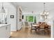 Bright open-concept living and dining area with hardwood floors and built-in shelving at 2578 Helmsman Rd, Johns Island, SC 29455