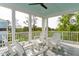 Relaxing covered porch with white Adirondack chairs overlooking lush greenery at 2578 Helmsman Rd, Johns Island, SC 29455