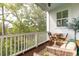 Covered porch with seating, a table, and views of the natural landscape at 2578 Helmsman Rd, Johns Island, SC 29455