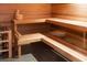 Inviting home sauna with wood paneled walls, bench seating, and traditional sauna accessories at 2578 Helmsman Rd, Johns Island, SC 29455