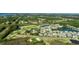 Wide aerial of community with houses lining a pond and golf course winding through landscape at 2645 Crooked Stick Ln, Mount Pleasant, SC 29466
