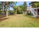 Spacious backyard with mature trees, lush lawn, and a glimpse of the home's deck, ideal for relaxation at 2645 Crooked Stick Ln, Mount Pleasant, SC 29466