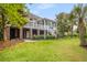 Beautiful backyard with elevated deck and screened porch, complemented by mature trees and manicured lawn at 2645 Crooked Stick Ln, Mount Pleasant, SC 29466