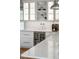 Close-up of a stylish bar area with a wine fridge and sleek white marble countertops at 2645 Crooked Stick Ln, Mount Pleasant, SC 29466