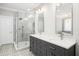 Contemporary bathroom showcases a glass-enclosed shower, dual vanity with granite countertops, and stylish lighting fixtures at 2645 Crooked Stick Ln, Mount Pleasant, SC 29466