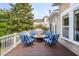 Charming deck area with fire pit and striped seating provides a comfortable outdoor living space with ample seating at 2645 Crooked Stick Ln, Mount Pleasant, SC 29466