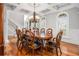 Charming dining room with hardwood floors, chandelier, and large windows with white shutters at 2645 Crooked Stick Ln, Mount Pleasant, SC 29466