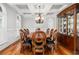 Elegant dining room boasts hardwood floors, a coffered ceiling, and a chandelier above the dining table at 2645 Crooked Stick Ln, Mount Pleasant, SC 29466