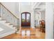 A stunning foyer with a grand staircase, elegant dining area, and gleaming hardwood floors at 2645 Crooked Stick Ln, Mount Pleasant, SC 29466