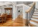 Inviting foyer featuring hardwood floors, staircase with iron railings, and decorative columns at 2645 Crooked Stick Ln, Mount Pleasant, SC 29466
