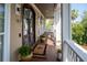 A charming front porch boasts elegant lantern lighting, potted plants, and a personalized welcome mat at 2645 Crooked Stick Ln, Mount Pleasant, SC 29466