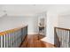 Bright hallway with hardwood floors and decorative wood and wrought iron banister railing at 2645 Crooked Stick Ln, Mount Pleasant, SC 29466