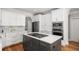 Stylish kitchen features a center island with a cooktop, modern appliances, and white cabinetry at 2645 Crooked Stick Ln, Mount Pleasant, SC 29466