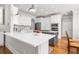 Spacious kitchen with white cabinets, a gray island, stainless steel appliances, and hardwood floors at 2645 Crooked Stick Ln, Mount Pleasant, SC 29466