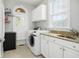 Efficient laundry room with modern washer and dryer, granite countertops, and ample storage cabinets at 2645 Crooked Stick Ln, Mount Pleasant, SC 29466