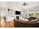 Open-concept living area with hardwood floors, built-in shelving, and a large window overlooking a patio at 2645 Crooked Stick Ln, Mount Pleasant, SC 29466