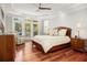 Serene main bedroom boasts tray ceilings, plush bedding, and an adjacent sitting area with outdoor access at 2645 Crooked Stick Ln, Mount Pleasant, SC 29466