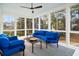 Inviting sunroom filled with light, featuring comfortable blue seating, perfect for relaxing and enjoying the views at 2645 Crooked Stick Ln, Mount Pleasant, SC 29466