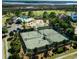 Aerial view of well-maintained tennis courts surrounded by trees in a charming community at 2645 Crooked Stick Ln, Mount Pleasant, SC 29466