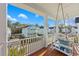 Charming balcony with a porch swing and scenic views of neighboring homes and lush landscaping at 2924 Tranquility Rd, Mount Pleasant, SC 29466