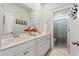 Bright bathroom with double sinks, a large mirror, and marble floors, providing a spacious and elegant feel at 2924 Tranquility Rd, Mount Pleasant, SC 29466