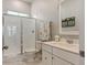 Modern bathroom featuring a glass-enclosed shower, white vanity, and marble flooring, offering a clean and stylish design at 2924 Tranquility Rd, Mount Pleasant, SC 29466