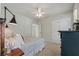 Bright bedroom with a ceiling fan, stylish lamp, closet, and neutral-toned patterned bedding at 2924 Tranquility Rd, Mount Pleasant, SC 29466