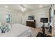 Comfortable bedroom with a ceiling fan, TV, dresser, exercise equipment, and ample natural light at 2924 Tranquility Rd, Mount Pleasant, SC 29466