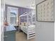 Bright bedroom with a loft bed, a lavender accent wall, and playful decor, creating a fun and inviting space at 2924 Tranquility Rd, Mount Pleasant, SC 29466