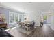 Elegant dining room with a geometric accent wall, large windows, and a modern chandelier at 2924 Tranquility Rd, Mount Pleasant, SC 29466