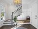 Bright entryway featuring a staircase, custom storage bench with baskets, and a decorative plant at 2924 Tranquility Rd, Mount Pleasant, SC 29466