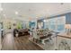 Open-concept living and dining area with wood floors, modern lighting, and a stylish dining table with bench seating at 2924 Tranquility Rd, Mount Pleasant, SC 29466